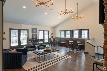 A living room with a couch, chairs, and a coffee table